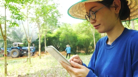 Asian Female farmer using tablet computer Stock Footage 106043635