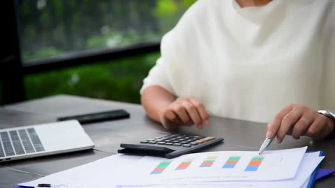 Asian Female freelance using laptop at home office desk Stockbeeldmateriaal 268777632