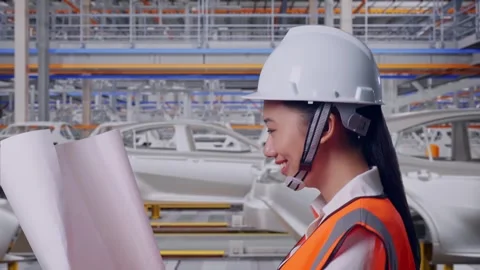 Asian Female Looking At Blueprint While Walking In Car Factory Stock Footage 331629150