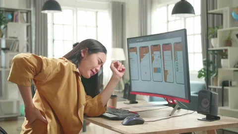 Asian Female Mobile Application Developer Paining Her Back While Works With Stock Footage 158099549