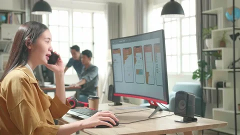 Asian Female Mobile Application Developer Works And Talking On Mobile Phone Stock Footage 158100637