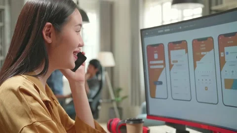 Asian Female Mobile Application Developer Works And Talking On Mobile Stock Footage 158102637