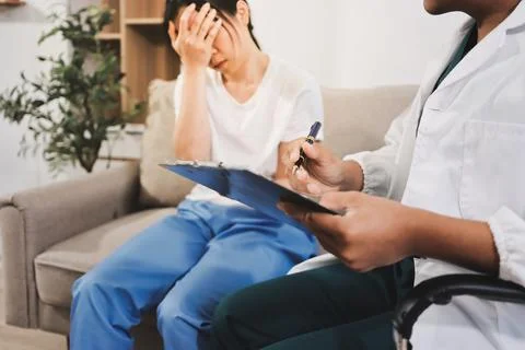 Asian female patient crying while consulting her health problem Stock Photos