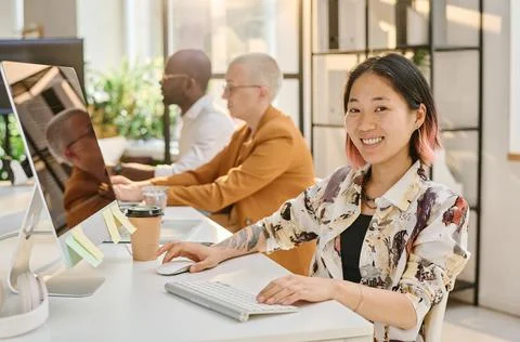 Asian female programmer working on computer Stock Photos