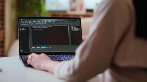 Asian female programmer works on coding software in a home office setup Stock Footage 319716548
