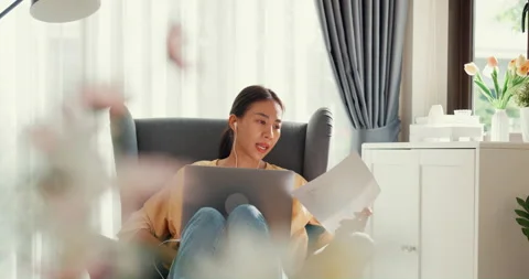 Asian female sit on sofa with computer laptop wear earphone online meeting. Stock Footage 202153651