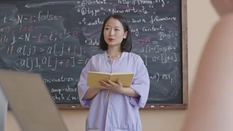 Asian Female Student Reading Notes by Chalkboard on Programming Class Stock Footage 257066665