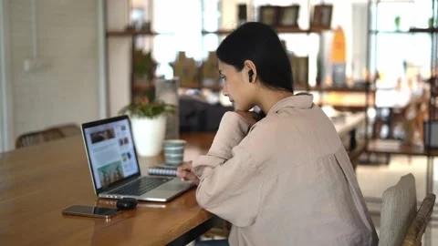 Asian female student study computer cafe. Woman read news. Girl internet learn. 動画素材 235761463