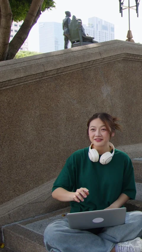Asian Female Student Using Laptop and Waving on University Campus Stairs Stock Footage 337918124