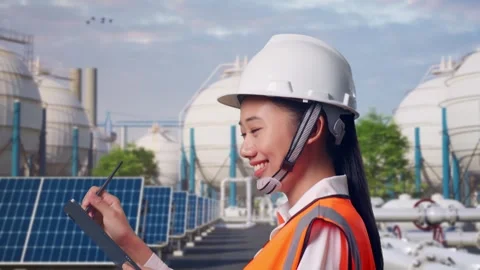 Asian Female Taking Note on Tablet While Walking at Energy Complex Stock Footage 330175644