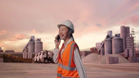 Asian Female Talking On Smartphone While Walking at Cement Plant Stock Footage 320107809