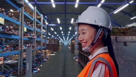 Asian Female Use Computer While Walking at Scrap Warehouse Stock Footage 318077426