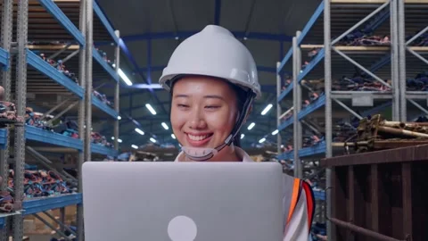 Asian Female Use Computer While Walking at Scrap Warehouse Stock Footage 318077966