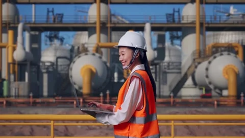 Asian Female Use Computer While Walking at Energy Plant Stock Footage 331194311