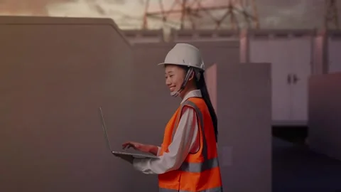Asian Female Use Computer While Walking with Electrical Energy Stock Footage 331288860