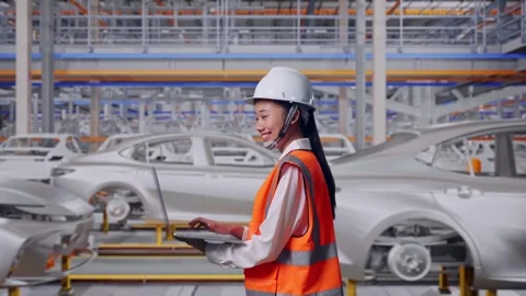 Asian Female Use Computer While Walking In Car Factory Stock Footage 331629258