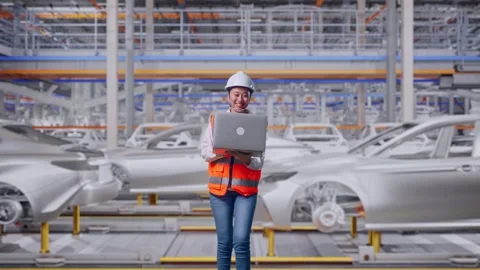 Asian Female Use Computer While Walking In Car Factory Stock Footage 331629576