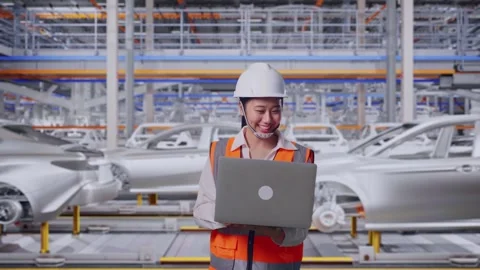 Asian Female Use Computer While Walking In Car Factory Stock Footage 331629777