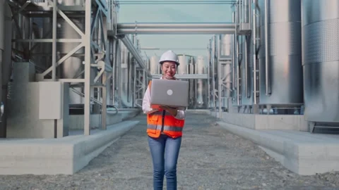 Asian Female Use Computer While Walking at Chemical Plant Stock Footage 332549578