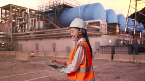 Asian Female Use Computer While Walking at Gas Plant Stock Footage 337758254