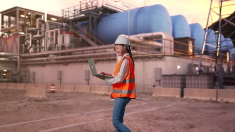 Asian Female Use Computer While Walking at Gas Plant Stock Footage 337758479