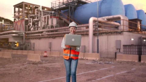 Asian Female Use Computer While Walking at Gas Plant Stock Footage 337758652