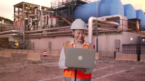 Asian Female Use Computer While Walking at Gas Plant Stock Footage 337758834