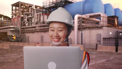 Asian Female Use Computer While Walking at Gas Plant Stock Footage 337758960
