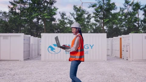 Asian Female Use Computer While Walking with Energy Storage Stock Footage 337810416
