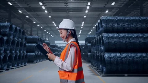 Asian Female Use Tablet While Walking with Rebar Coils Stock Footage 323691248