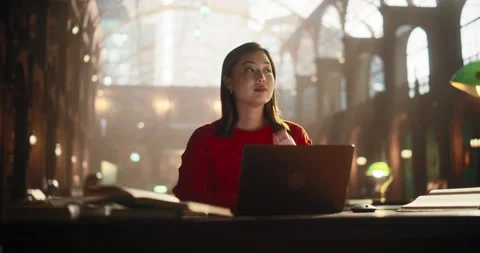 Asian Female Using Laptop in Library Stock Footage 251805331