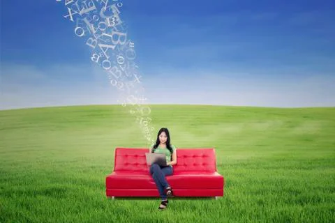 Asian female using laptop on sofa with flying letters outdoor Stock Illustration