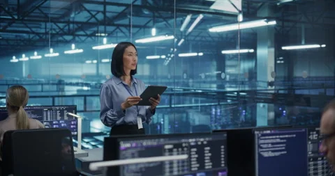 Asian Female Using Tablet in Data Center Office Stock Footage 296174518