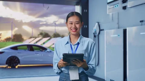 Asian Female Worker Use Tablet And Smiling To Camera With Energy Storage Stockbeeldmateriaal 295134377