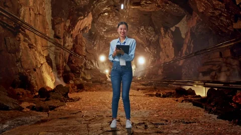 Asian Female Worker Use A Tablet And Smiling To Camera In Mine Tunnel Stock Footage 299581360
