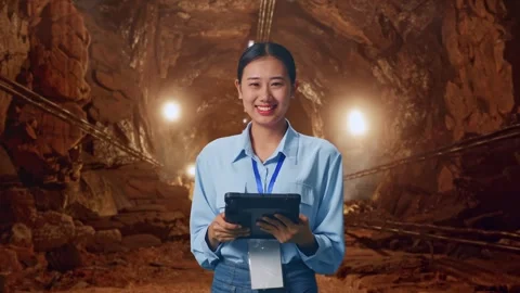 Asian Female Worker Use Tablet And Smiling To Camera In Mine Tunnel Stock Footage 299582534