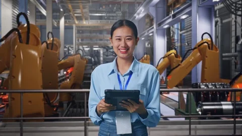 Asian Female Worker Use Tablet And Smiling To Camera With Robotic Arms Stock Footage 301932099