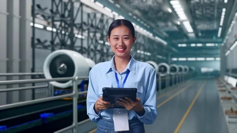 Asian Female Worker Use Tablet And Smiling To Camera, Aircraft Engine Factory Stock Footage 314610083