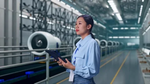 Asian Female Worker Use Tablet And Look Around, Aircraft Engine Factory Video stock 314610126