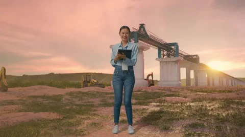 Asian Female Worker Use A Tablet And Smiling To Camera at Construction Site Stock Footage 330334485
