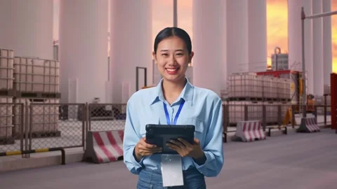 Asian Female Worker Use Tablet And Smiling To Camera at Storage Facility Stock Footage 337755949