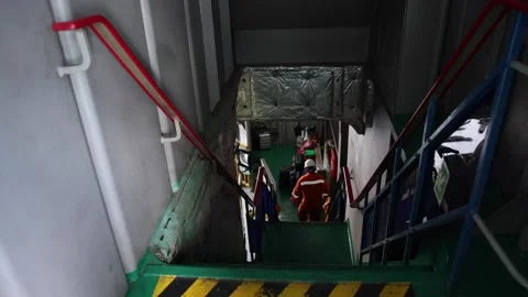 Asian Ferry Workers walking into engine room of big ship Mechanic Video stock 253240110