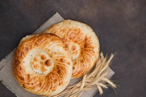 Asian flatbread on brown background, top view. Stock Photos