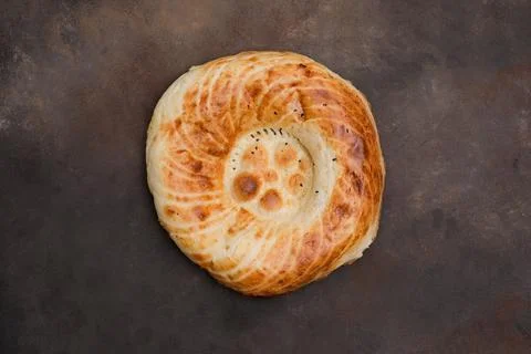 Asian flatbread on brown background, top view. Stock Photos