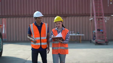 Asian foreman and harbor worker woman discussion and using digital tablet and Stock Footage 157715390
