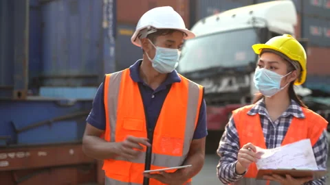 Asian foreman and harbor worker woman discussion and using digital tablet and Stock Footage 157715655