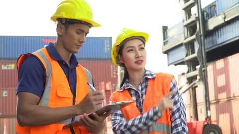 Asian foreman and harbor worker woman discussion and using clipboard checking Stock Footage 157716213