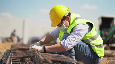 Asian foreman wearing protective face mask checking steel structure outdoors Stock Footage 146442505