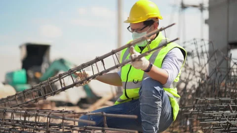 Asian foreman wearing protective face mask checking steel structure outdoors Stock Footage 146443134