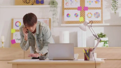 Asian freelancer answer the call during work at home and looking on document  Video stock 172253822
